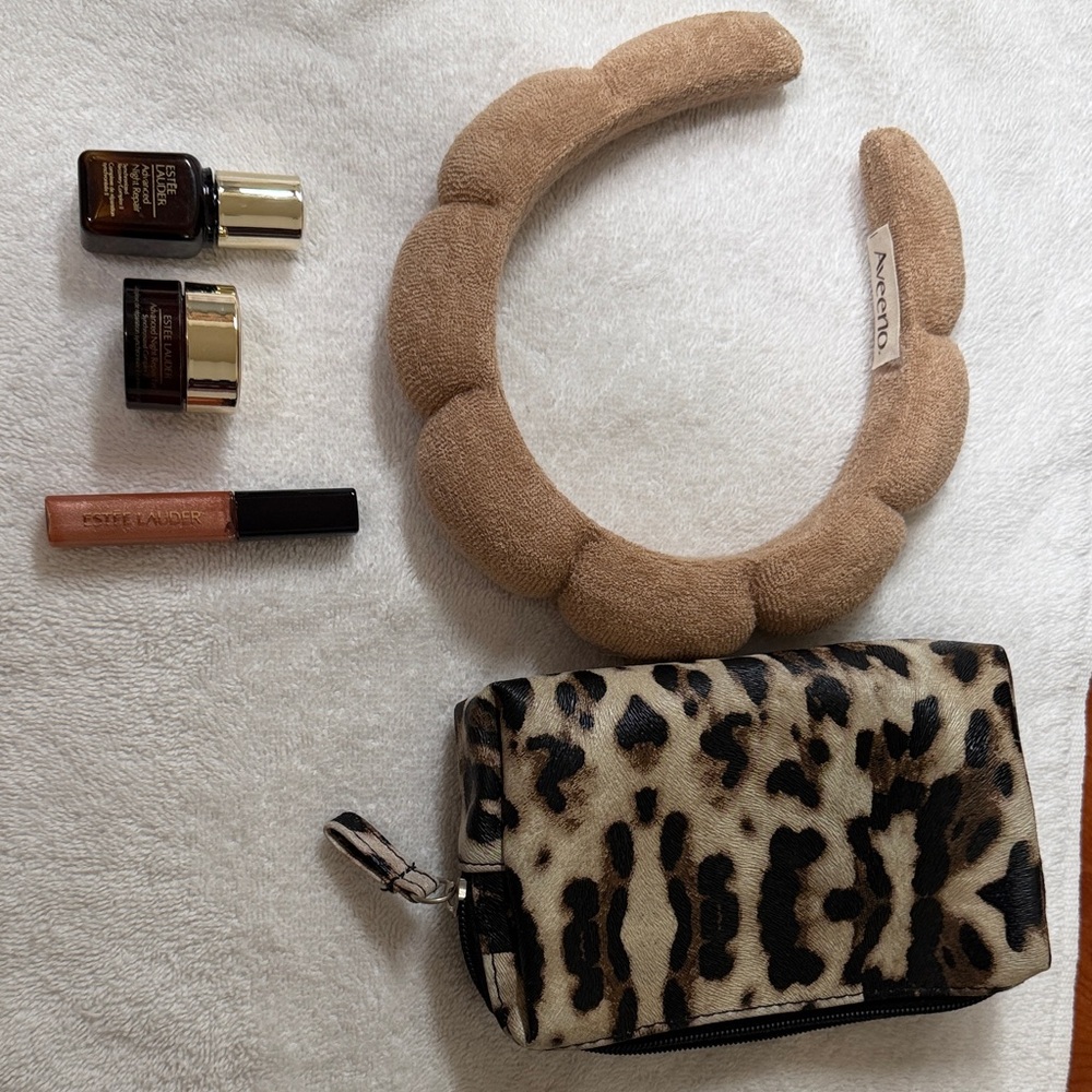 Aveeno Tan Hairband with Estée Lauder mini samples and  a small makeup bag